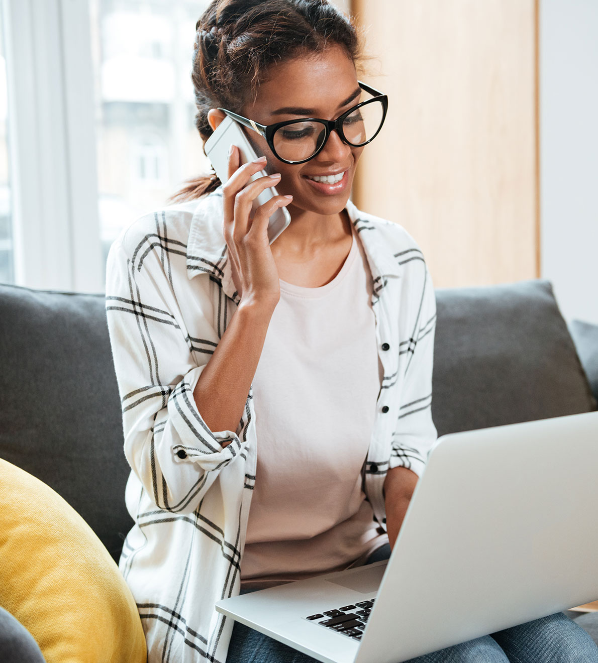 Woman on computer speaking on phone